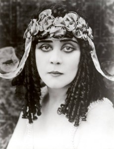 Theda Bara (born Theodosia Goodman, 1885–1955), Jewish silent screen actress famous for her femme fatale roles. Note the corkscrew curls mentioned earlier by Keats (“curled Jewesses”). The classic Hollywood femme fatale, Wikipedia tells us, was “often foreign, of an indeterminate Eastern European or Asian ancestry.” THEDA BARA, by the way, is an anagram for ARAB DEATH. Go figure.
